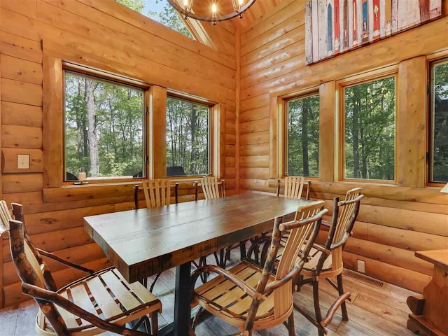 dining space with rustic walls and light hardwood / wood-style floors