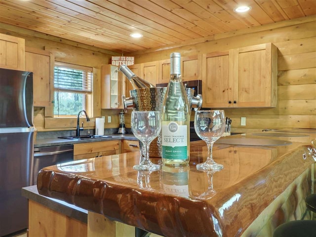 kitchen with wood ceiling, appliances with stainless steel finishes, light brown cabinetry, and sink