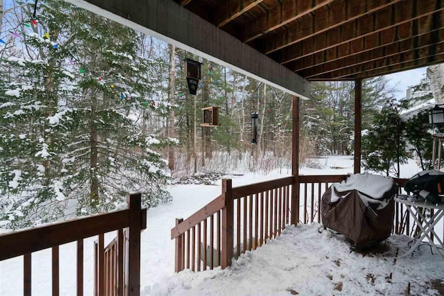 snow covered deck featuring grilling area