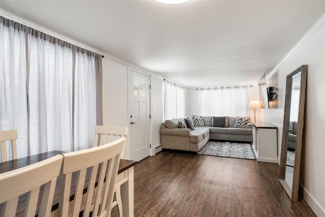 living room with crown molding, dark hardwood / wood-style floors, and baseboard heating