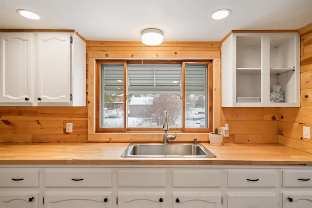 kitchen featuring white cabinetry and sink