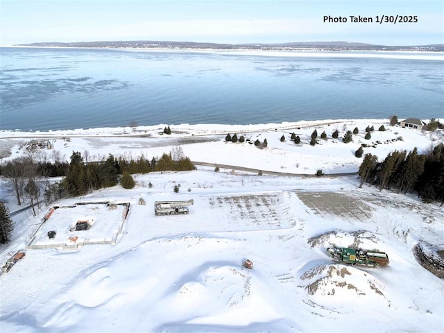 snowy aerial view with a water view