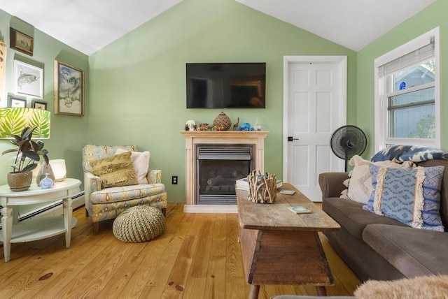 living room featuring lofted ceiling and light hardwood / wood-style floors