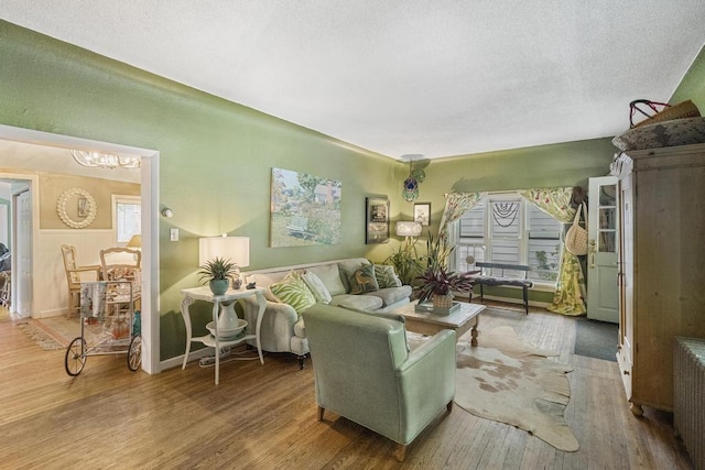 living room featuring wood-type flooring and radiator heating unit