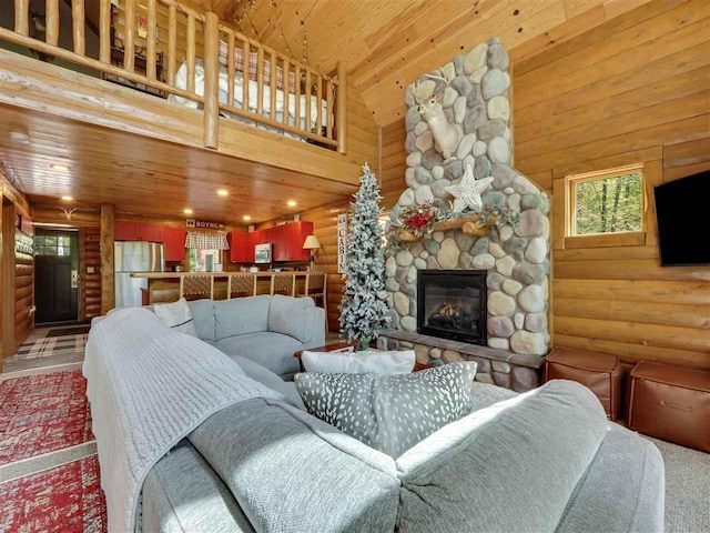 living room with a towering ceiling, a stone fireplace, log walls, and wooden ceiling