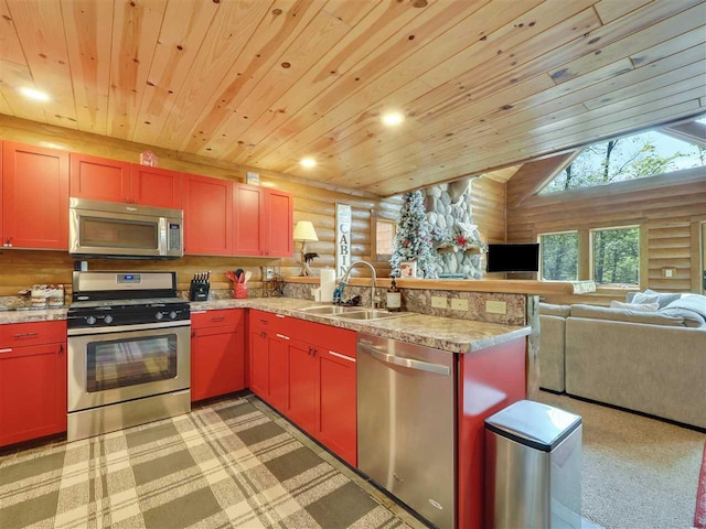 kitchen with lofted ceiling, appliances with stainless steel finishes, log walls, and sink