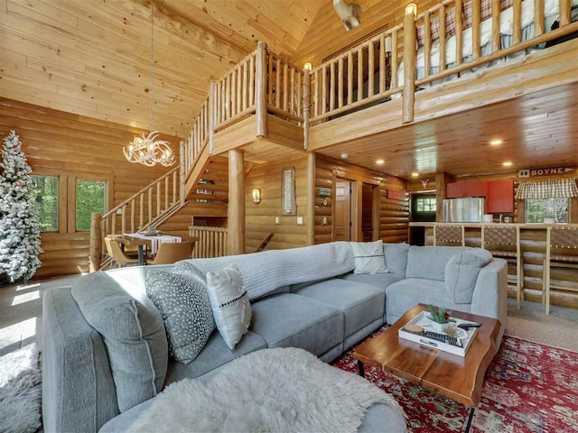 living room with wood ceiling, a chandelier, high vaulted ceiling, log walls, and carpet