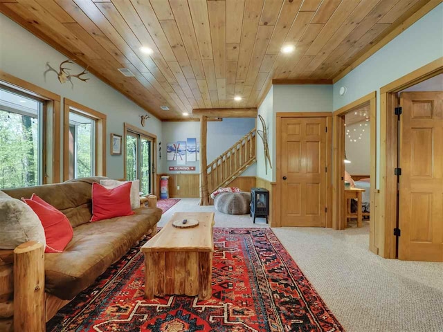 carpeted living room featuring wood ceiling