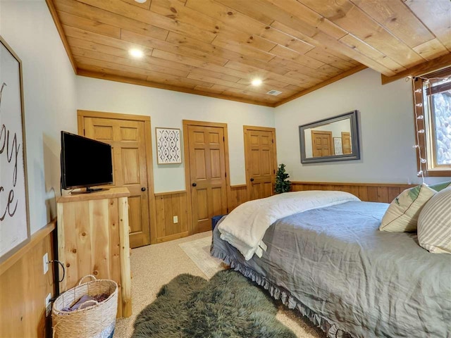 carpeted bedroom with ornamental molding, wooden walls, and wooden ceiling