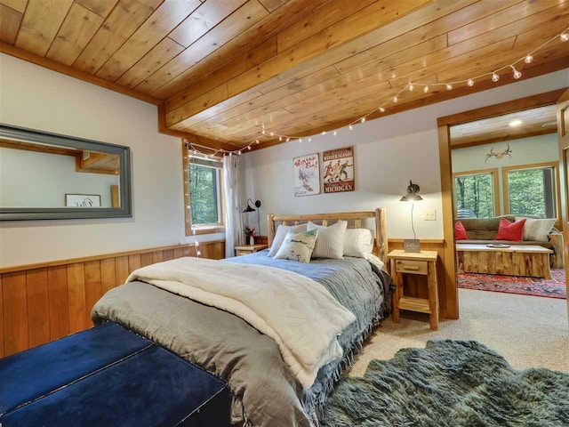 bedroom featuring wooden walls, carpet floors, rail lighting, and wooden ceiling