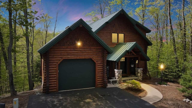 log cabin featuring a garage