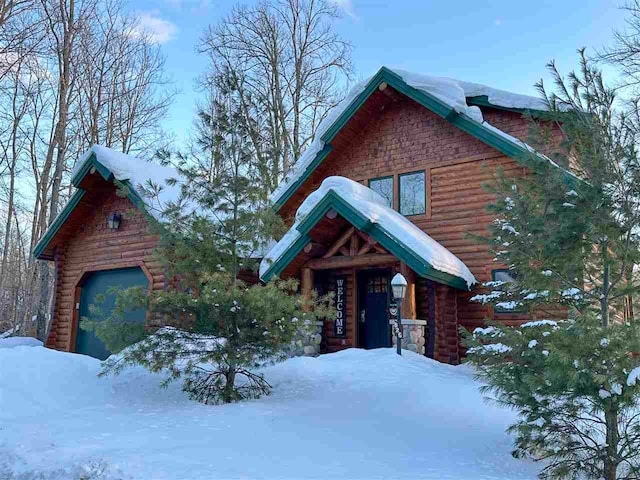 log cabin featuring a garage