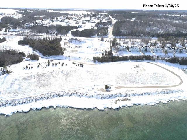 snowy aerial view with a water view