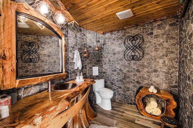 bathroom with lofted ceiling, sink, hardwood / wood-style floors, wooden ceiling, and toilet