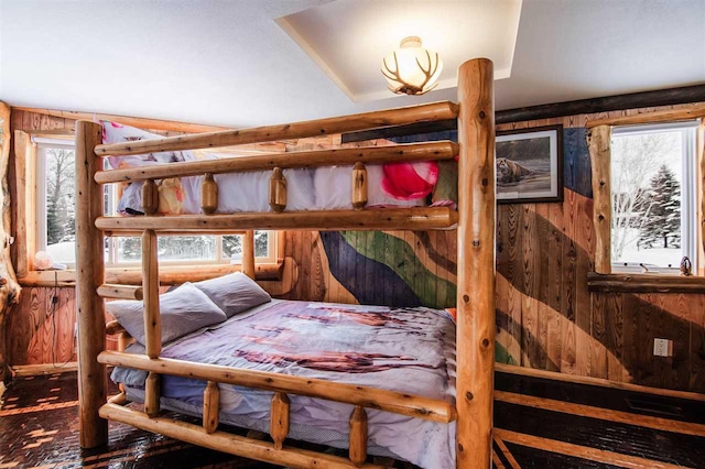 bedroom featuring rustic walls and wood walls