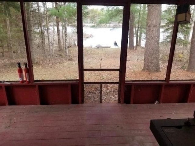 unfurnished sunroom with a water view