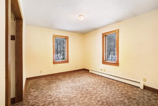 carpeted spare room with a baseboard radiator