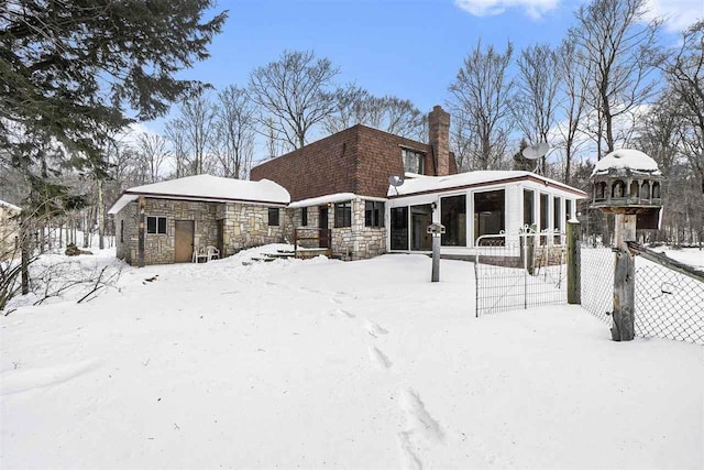 view of snow covered rear of property