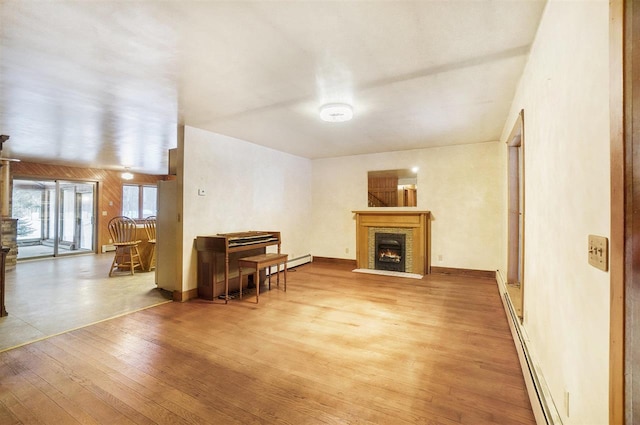 living room featuring a baseboard heating unit and wood-type flooring