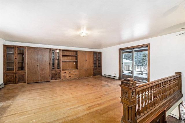 living room with light wood-type flooring and baseboard heating