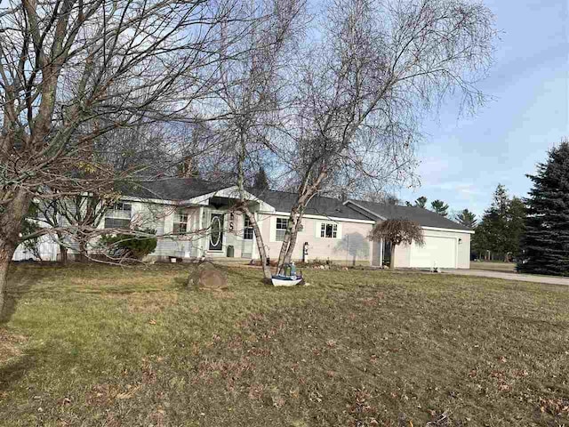 single story home with a garage and a front yard