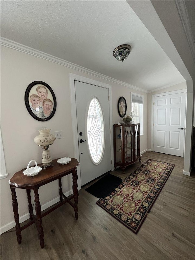 entrance foyer with crown molding, dark hardwood / wood-style floors, and a textured ceiling