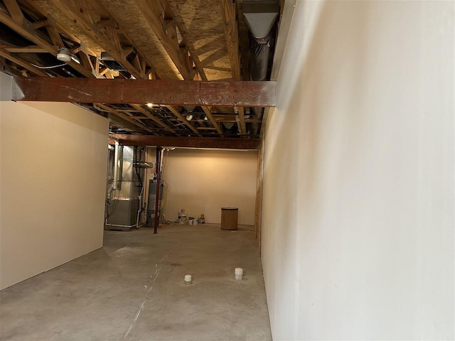 basement featuring water heater and heating unit