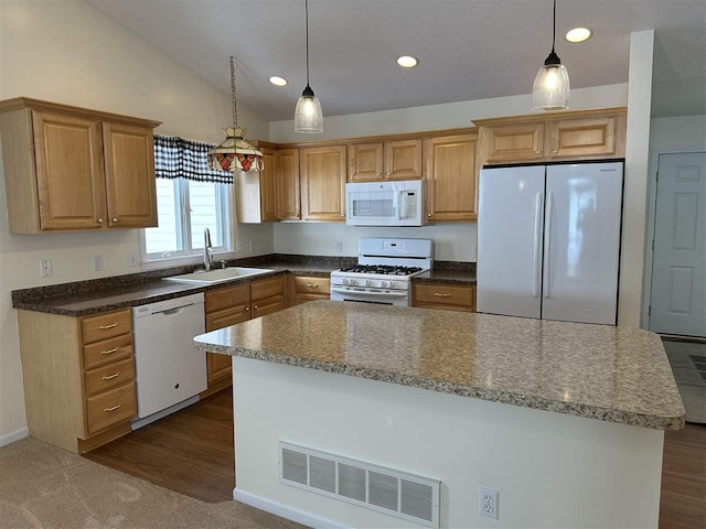 kitchen with sink, decorative light fixtures, a center island, vaulted ceiling, and white appliances