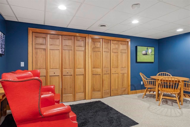 interior space featuring light carpet and a drop ceiling