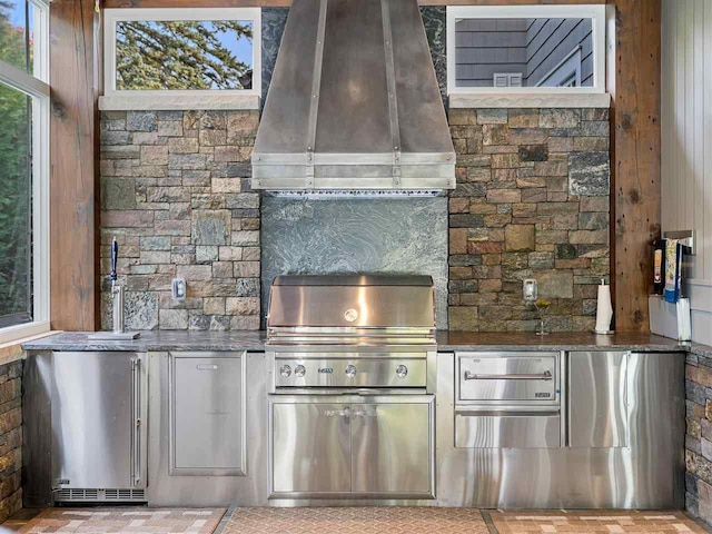 kitchen with island range hood and backsplash