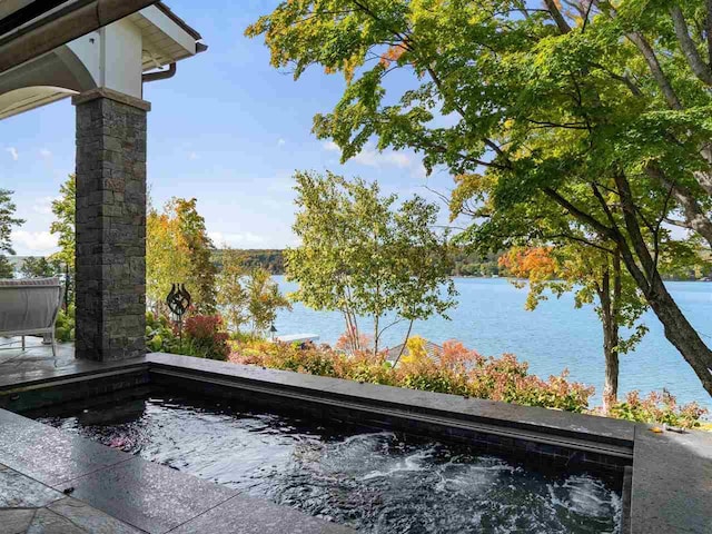 view of swimming pool with a water view