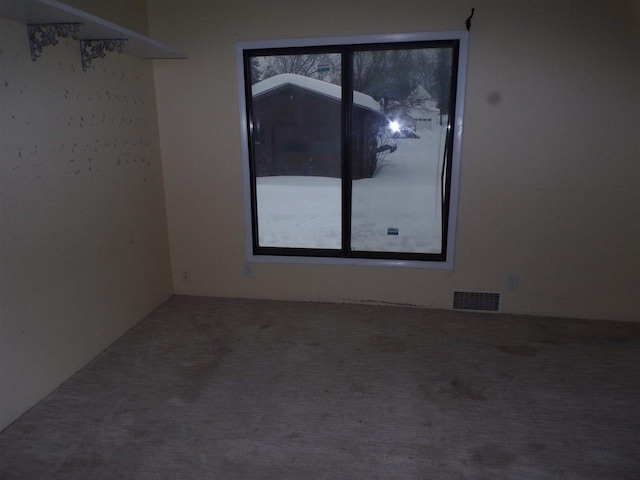 carpeted spare room featuring plenty of natural light