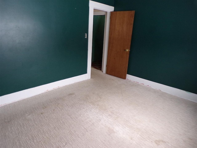 unfurnished room with light colored carpet