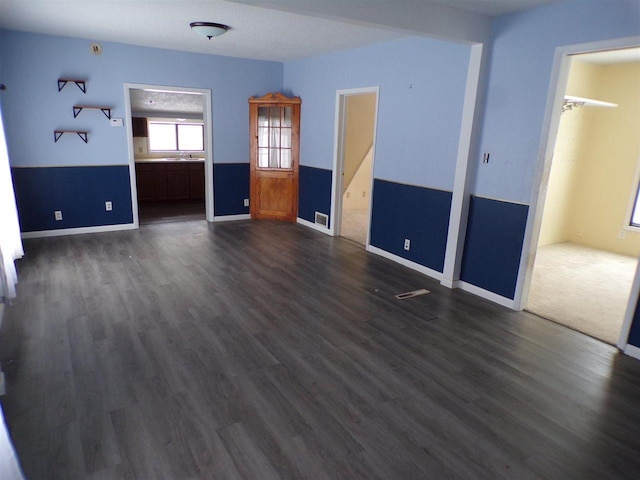 unfurnished bedroom with dark wood-type flooring and sink