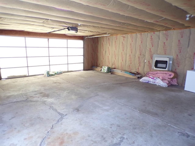 garage with a garage door opener and heating unit