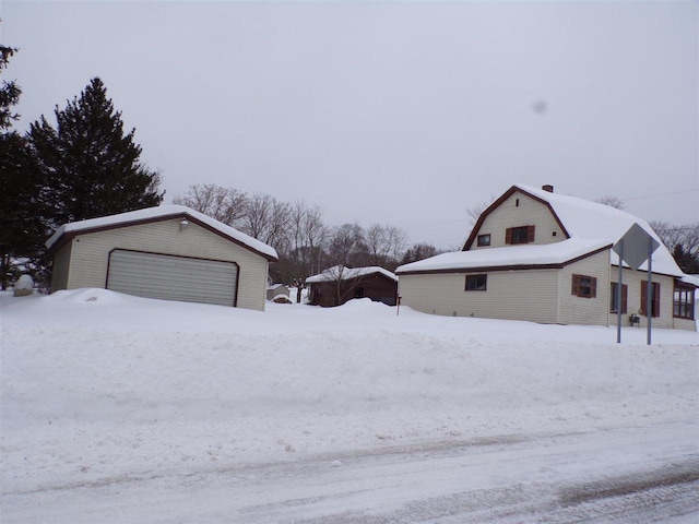 exterior space featuring a garage and an outdoor structure