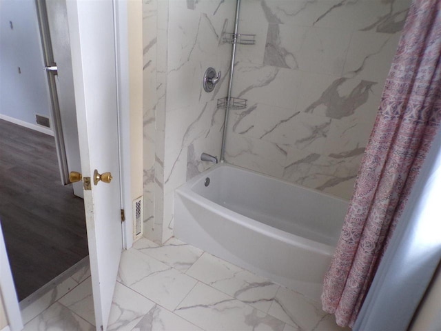 bathroom with shower / tub combo with curtain