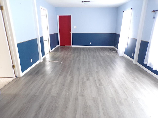 unfurnished room with hardwood / wood-style floors