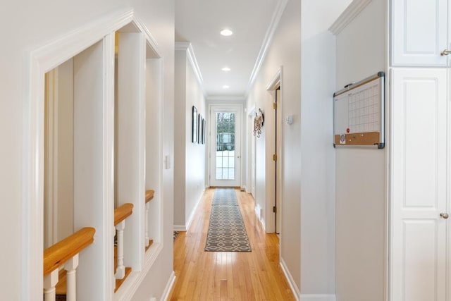 hall with crown molding, light wood-type flooring, recessed lighting, and baseboards