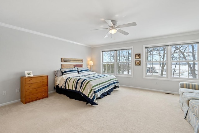 bedroom with light colored carpet, crown molding, and baseboards