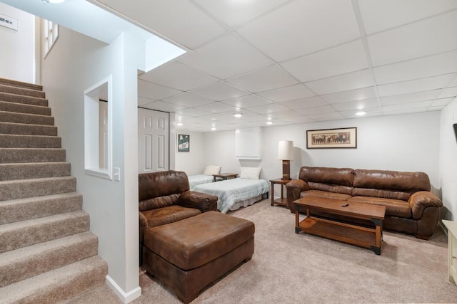 living room featuring visible vents, light carpet, stairs, and a paneled ceiling