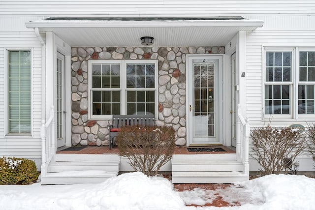 view of snow covered property entrance