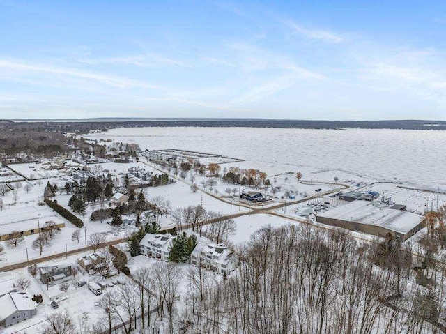 snowy aerial view with a water view