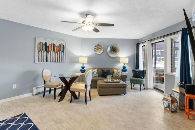 interior space with light hardwood / wood-style flooring, a textured ceiling, ceiling fan, and baseboard heating