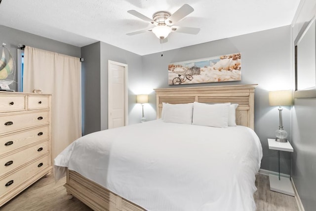 bedroom featuring ceiling fan and light hardwood / wood-style floors