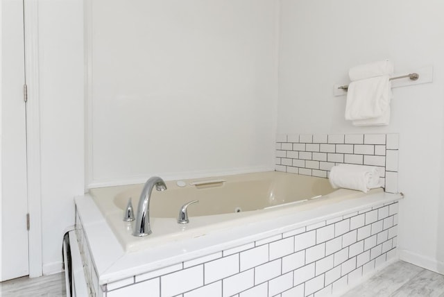 bathroom featuring a relaxing tiled tub