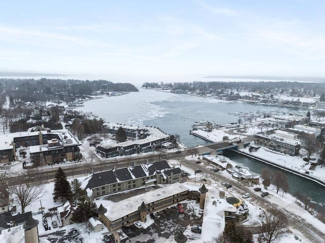 snowy aerial view featuring a water view