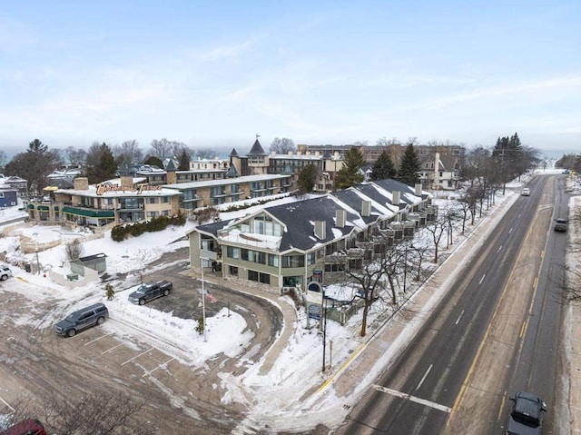 snowy aerial view with a residential view