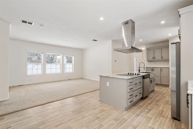 kitchen with gray cabinetry, island range hood, an island with sink, stainless steel appliances, and decorative backsplash