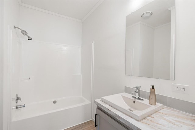 bathroom with crown molding, tub / shower combination, hardwood / wood-style floors, and vanity